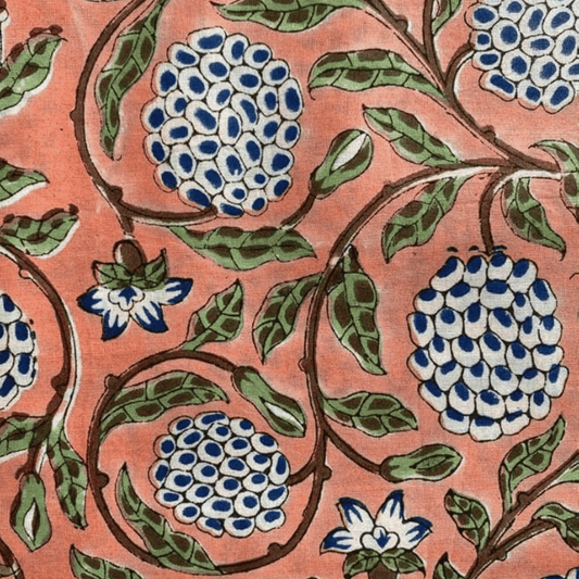 Close-up of a floral pattern with blue and white flowers on a pink background