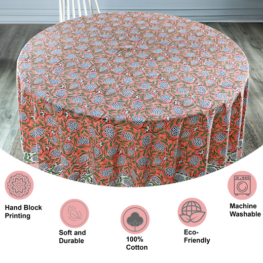 Round tablecloth with floral pattern on a wooden floor, featuring icons and text about material and care.