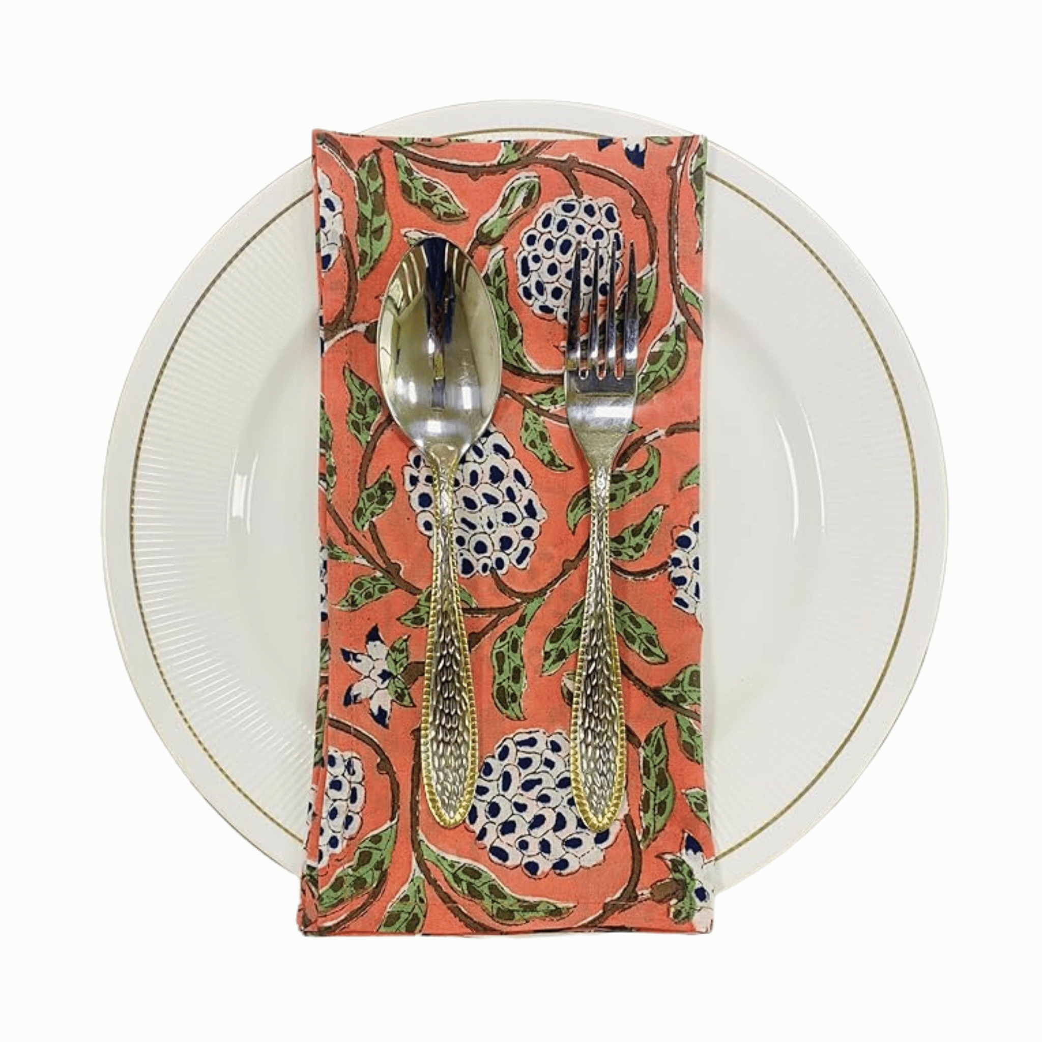 Napkin with floral pattern holding a spoon and fork on a white plate.