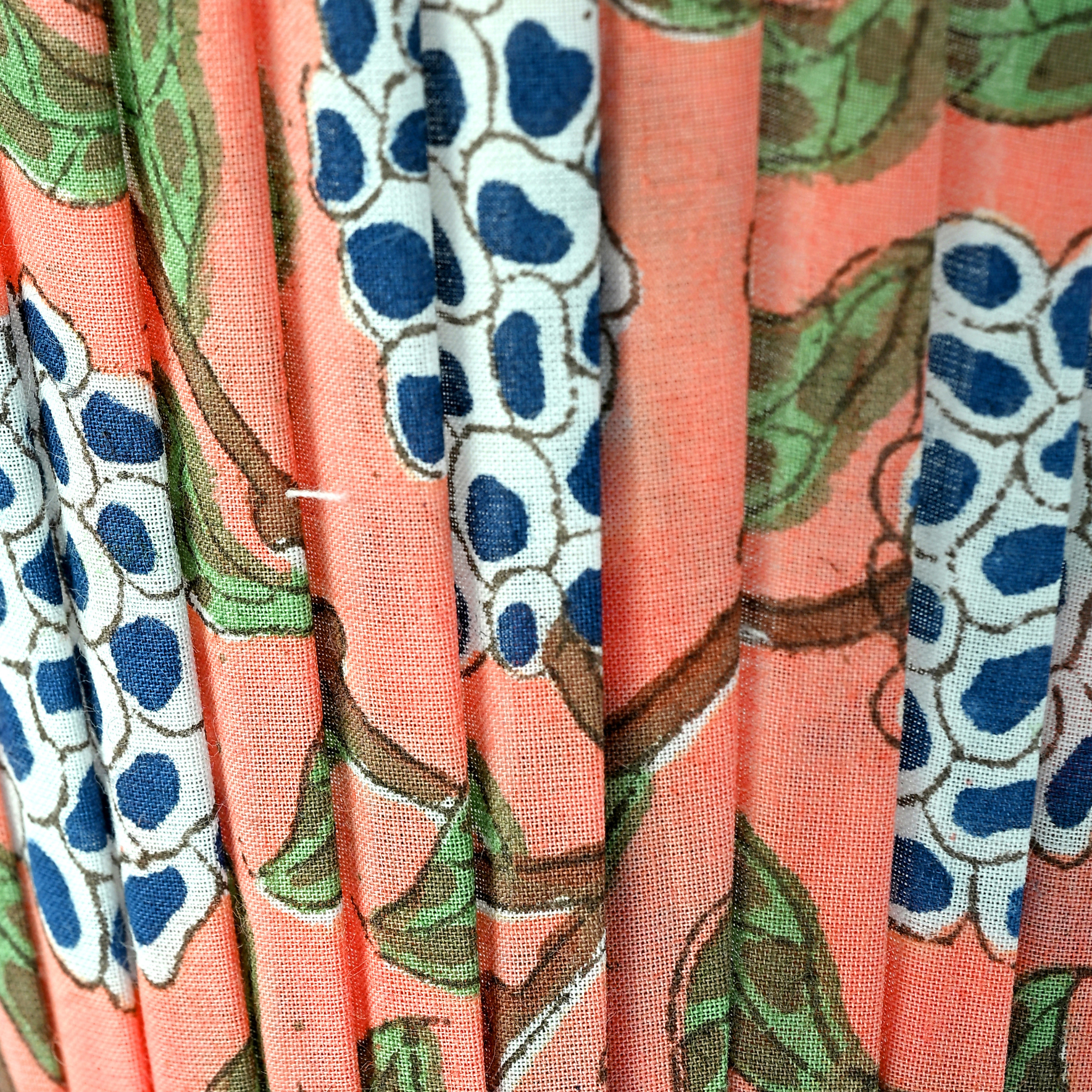 Close-up of fabric with floral pattern on a pink background