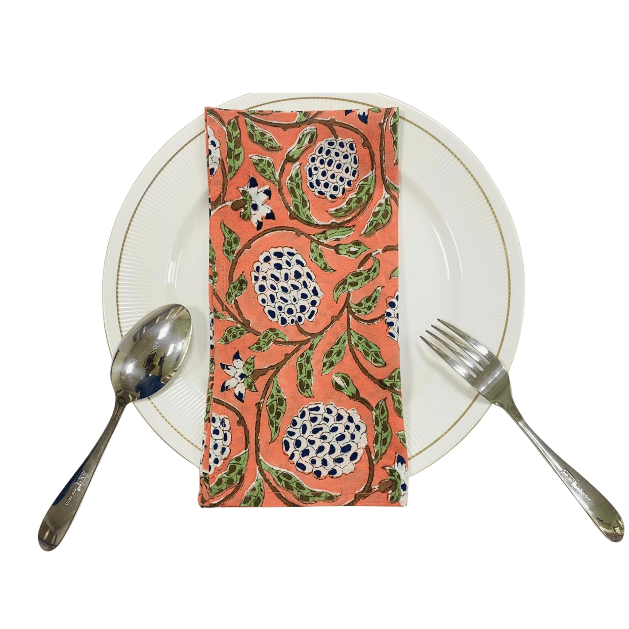 Napkin with floral pattern on a white plate with cutlery