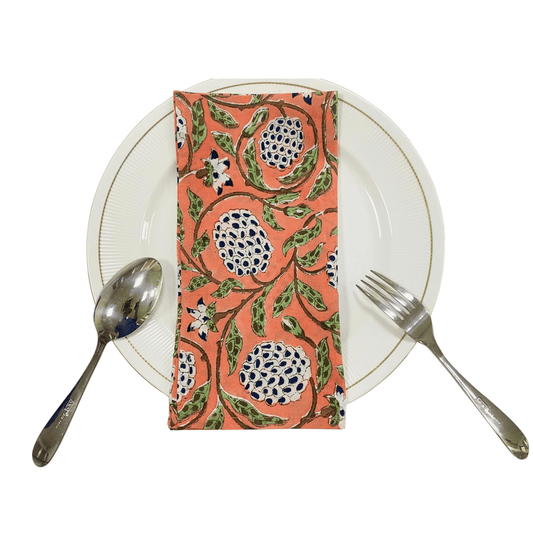 Napkin with floral pattern on a white plate with cutlery