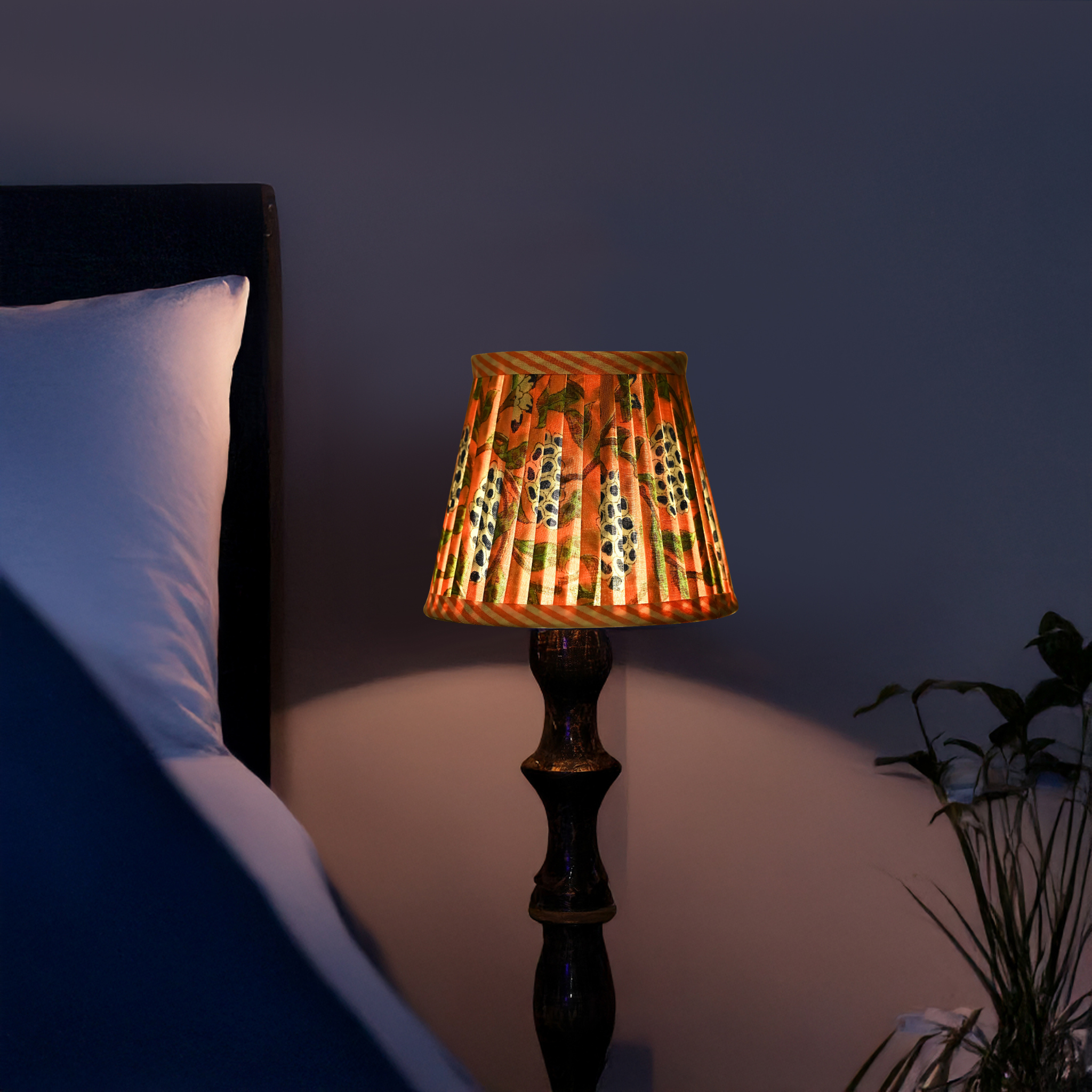Decorative lamp on a bedside table with a dark background