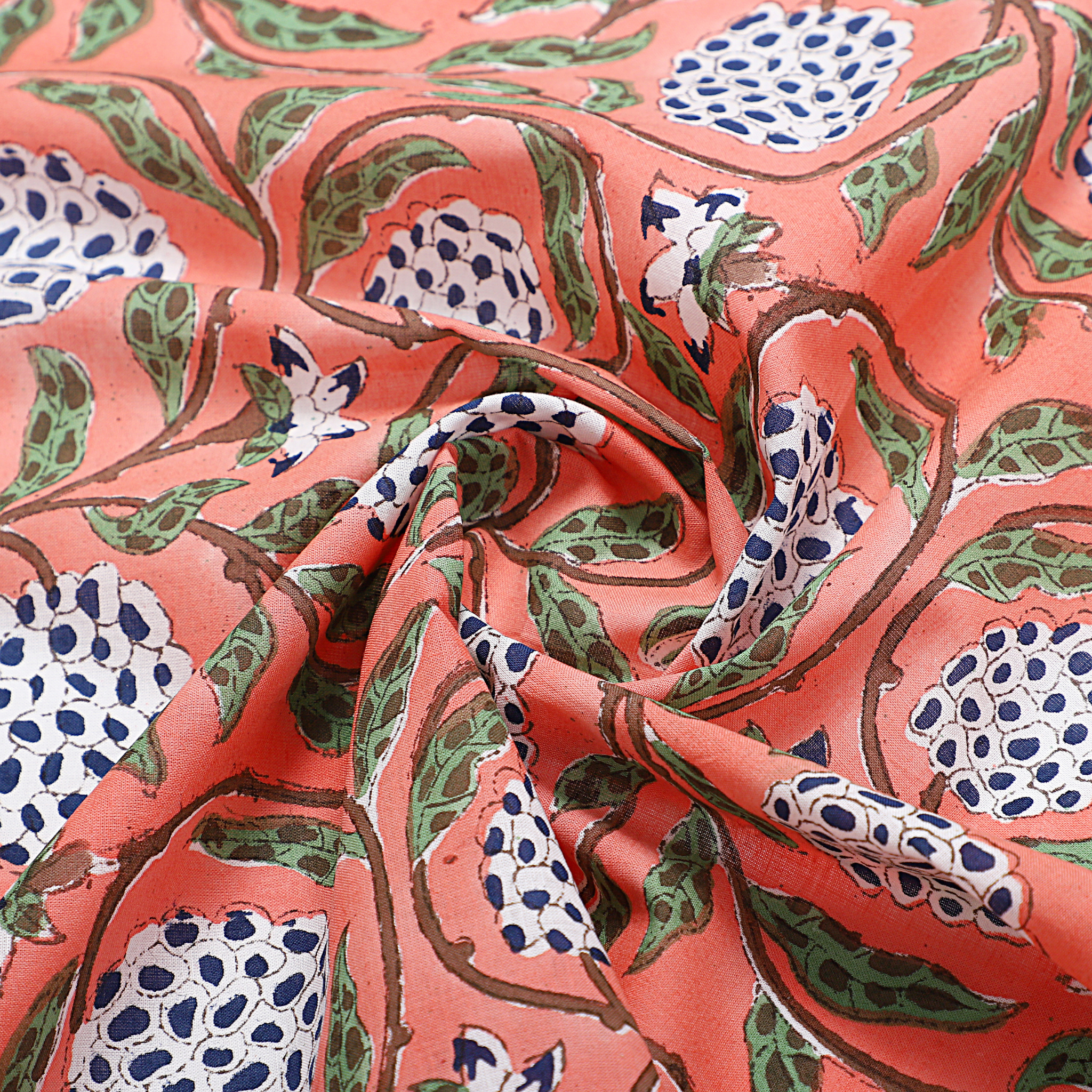 Close-up of fabric with a floral pattern on a coral background