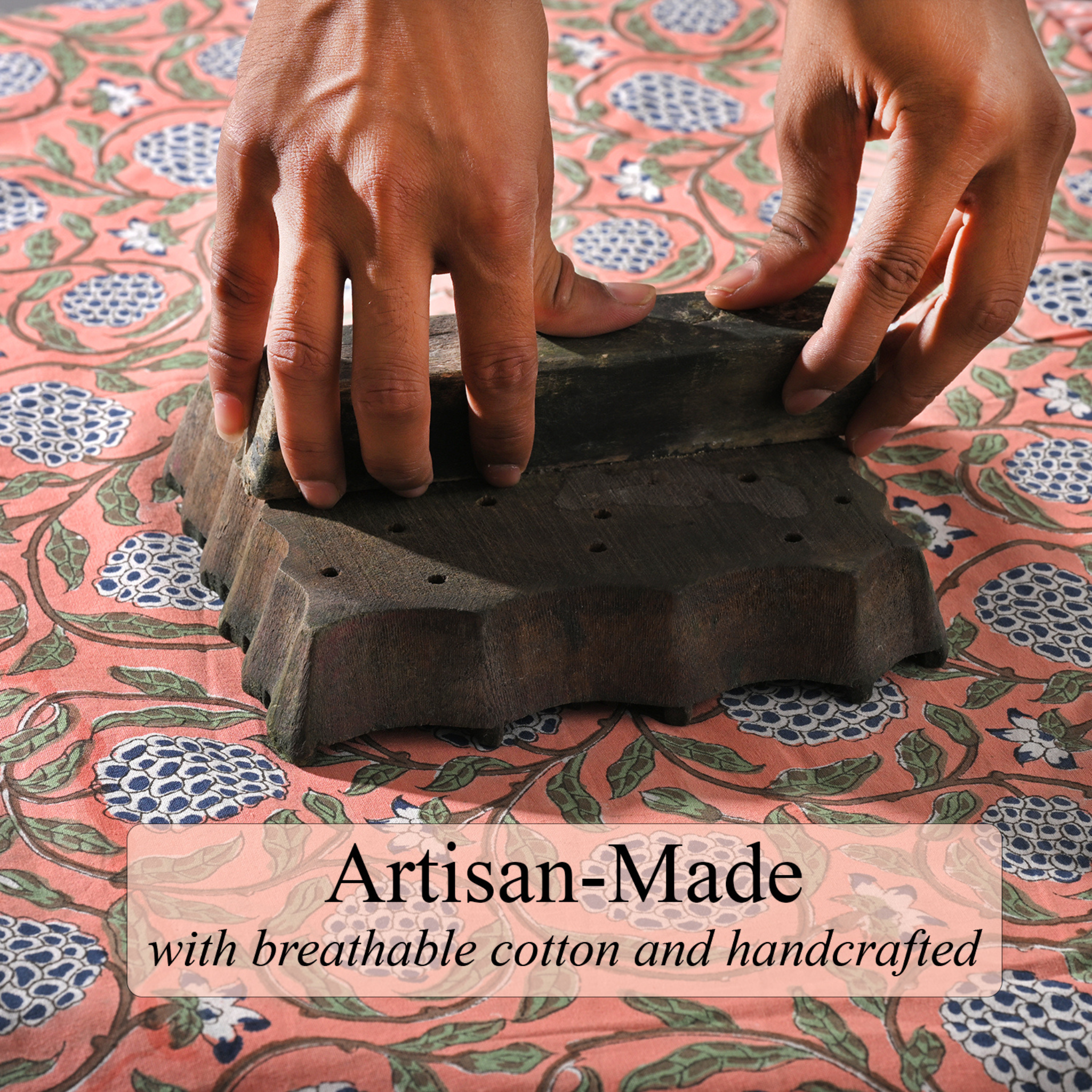 Hand using a traditional textile printing block on fabric with 'Artisan-Made' text overlay.