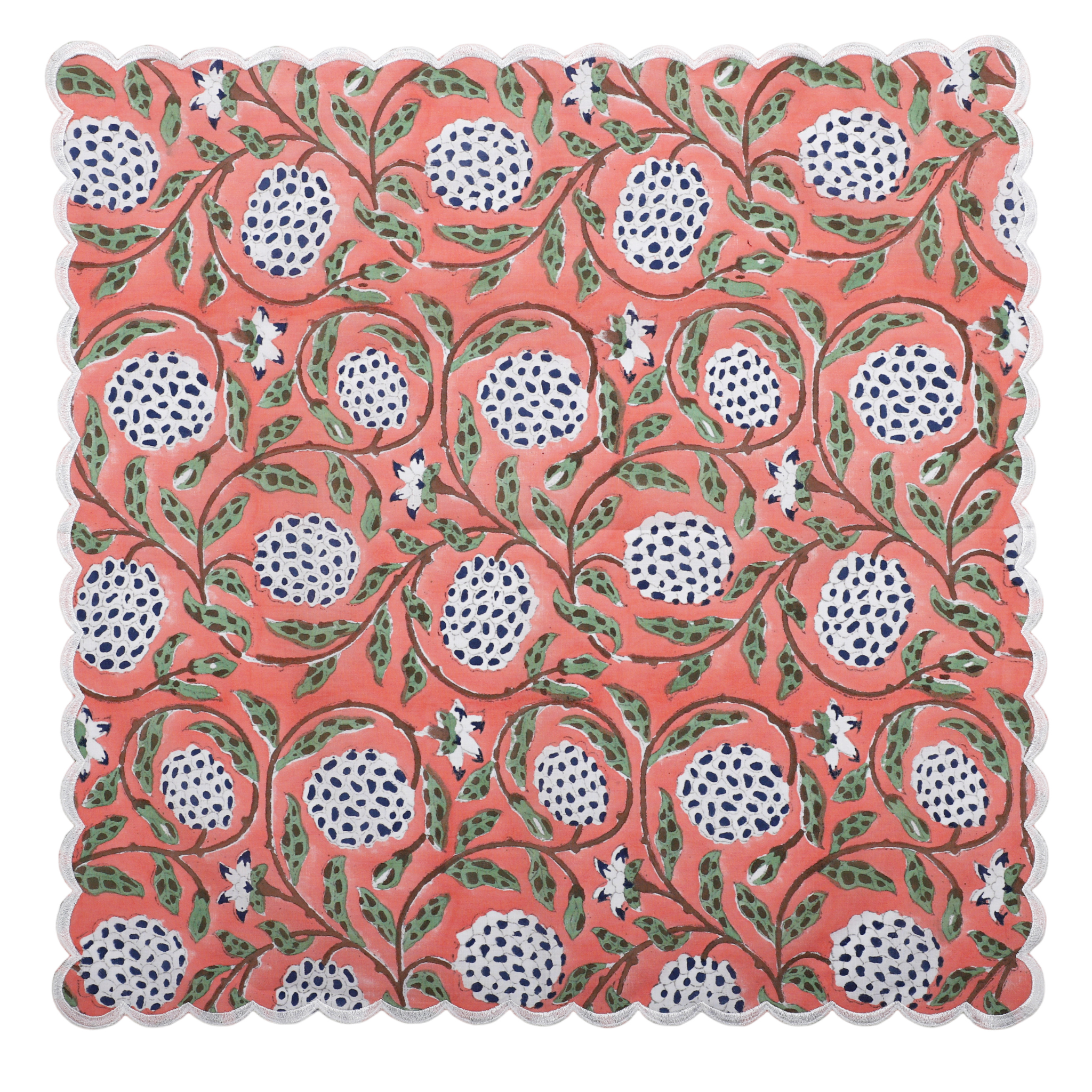 Patterned fabric with pomegranate design on a coral background