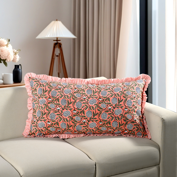 pink floral block print cotton pillow styled on a beige sofa in living room.
