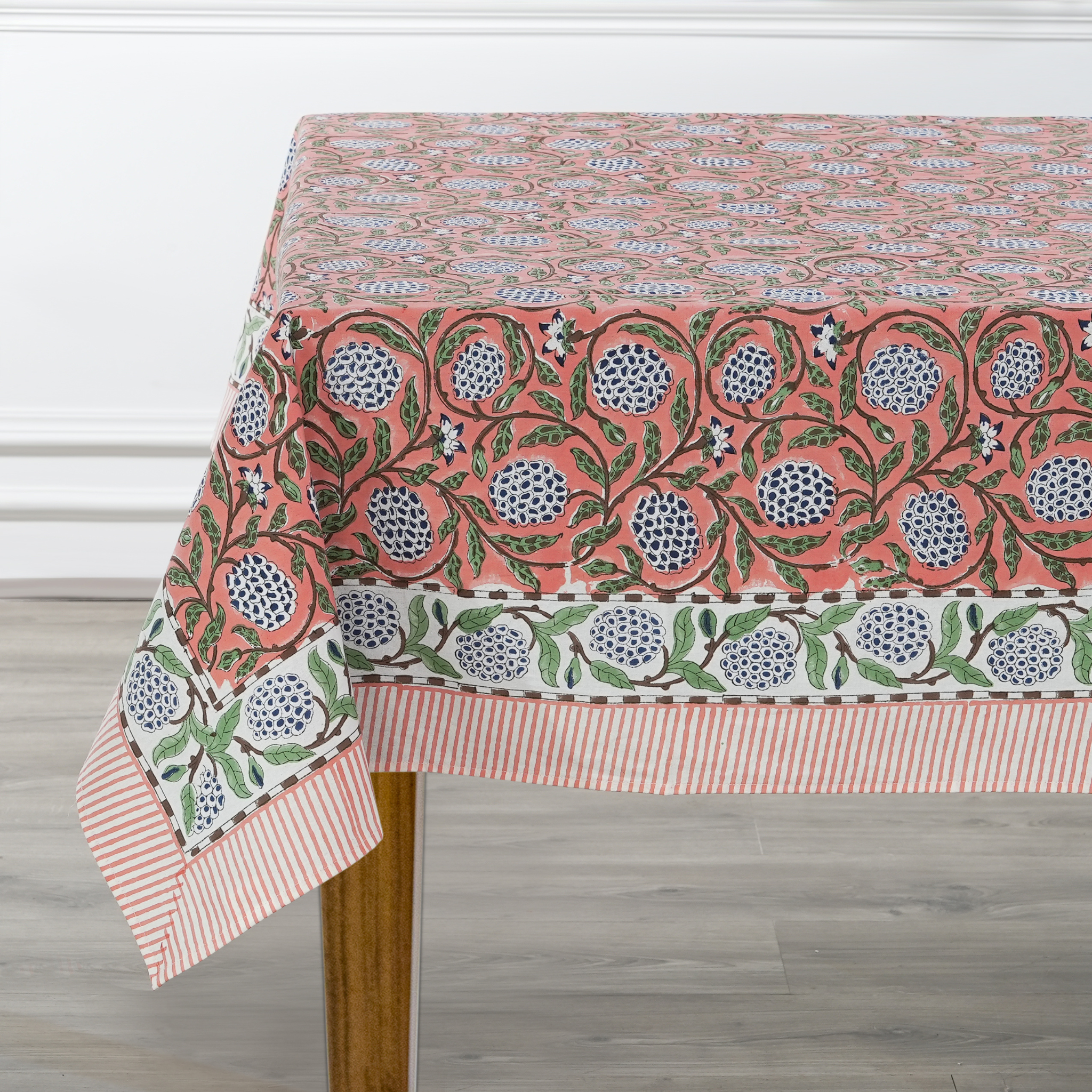 Decorative tablecloth with floral pattern on a wooden table