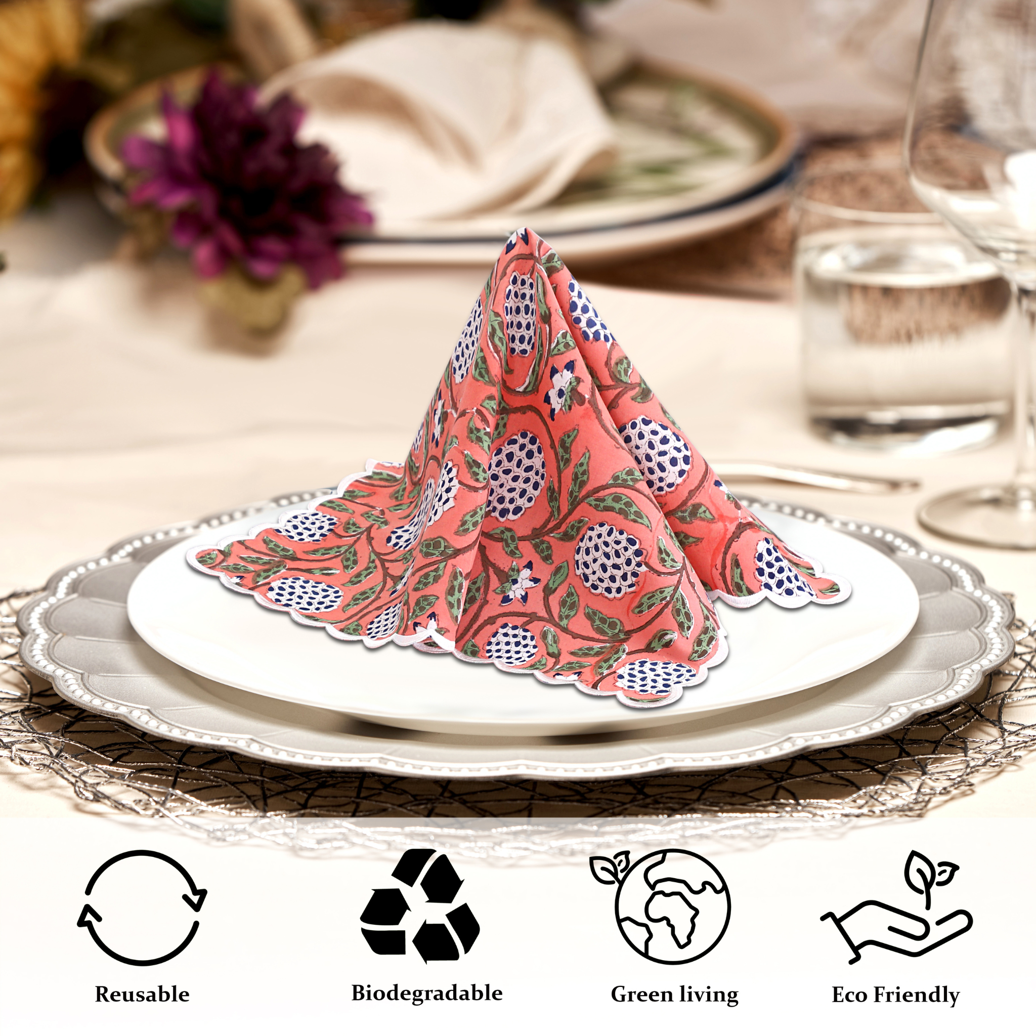 Decorative folded napkin on a plate with table setting and 'reuseable', 'biodegradable', 'green living', and 'eco-friendly' icons.