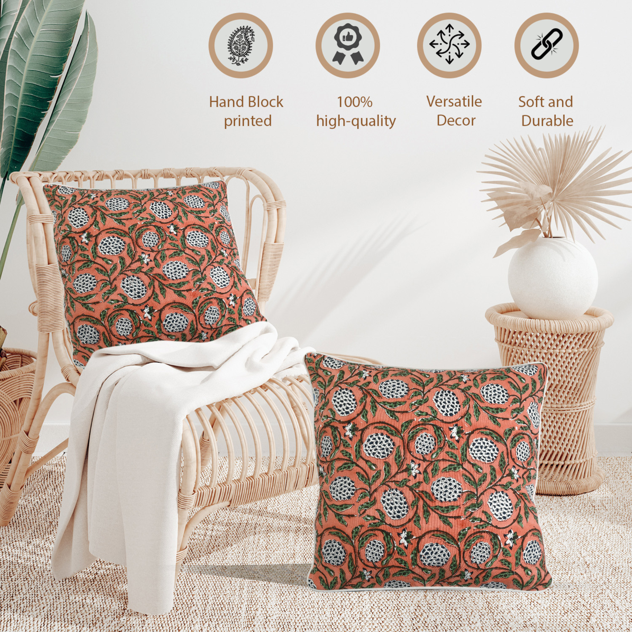 Decorative pillows with floral patterns on a wicker chair, surrounded by plants and decor items.