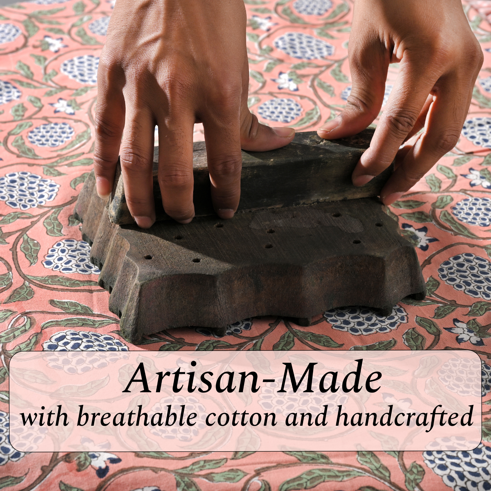 Handmade iron on a floral patterned fabric with 'Artisan-Made' text.