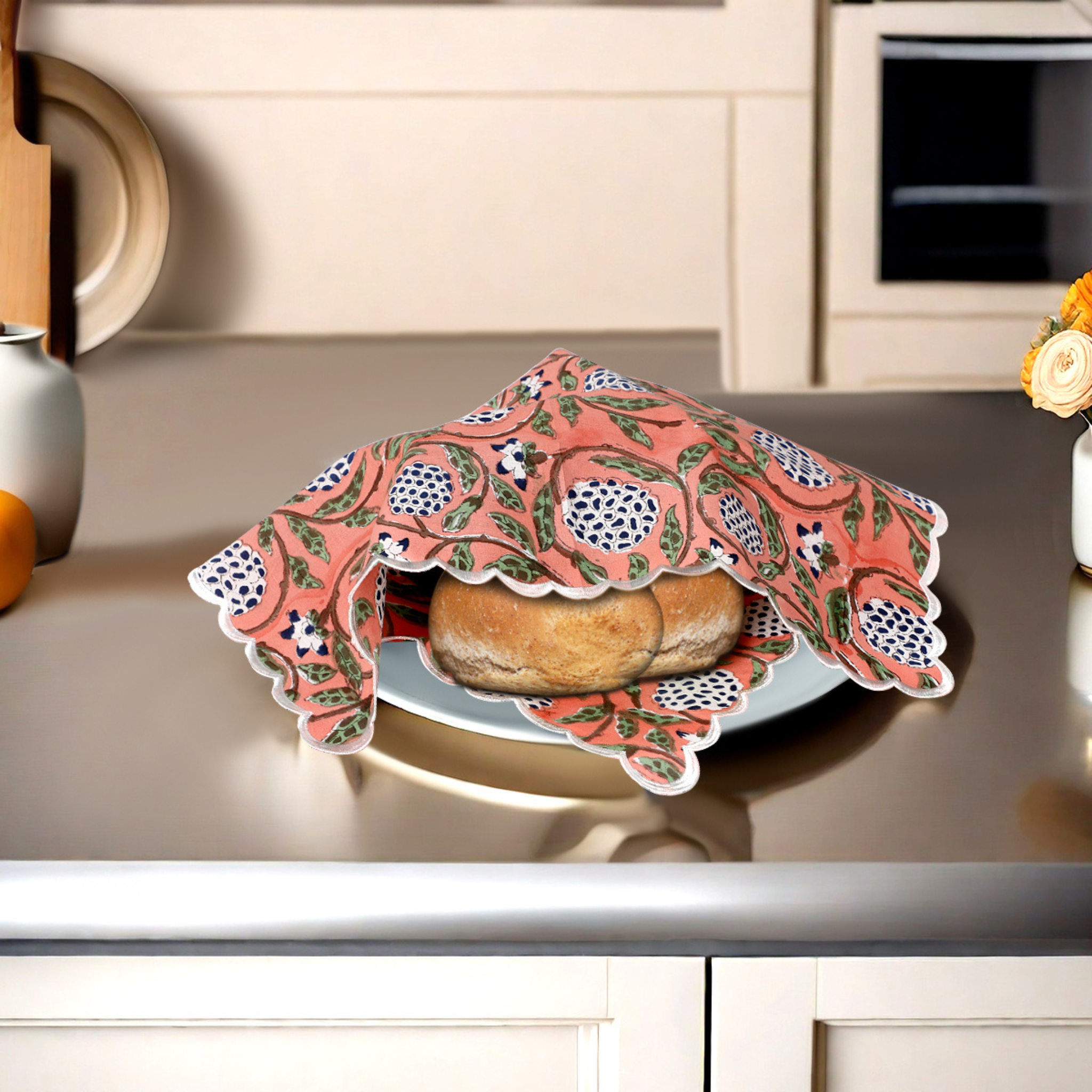 Baked goods on a plate with a decorative pink cloth in a kitchen setting