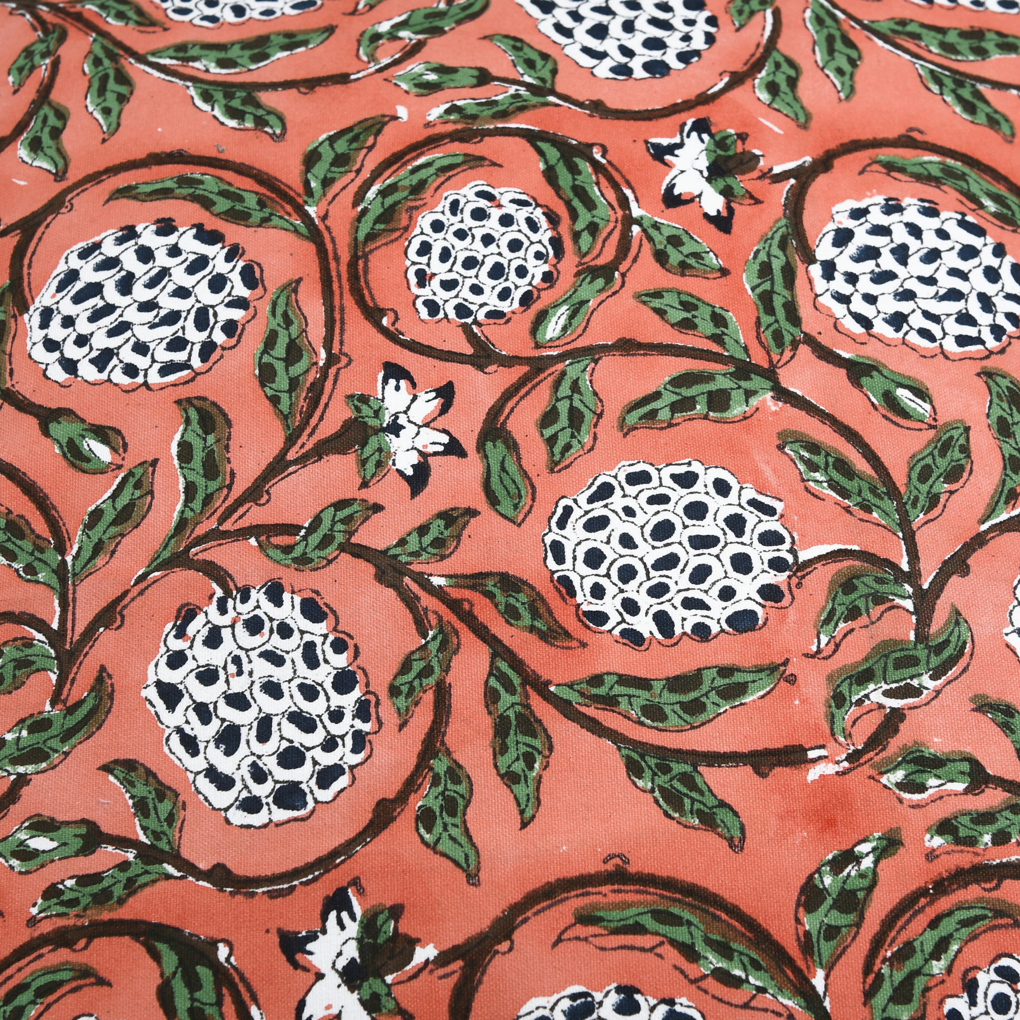 Patterned fabric with pomegranate design on a red background