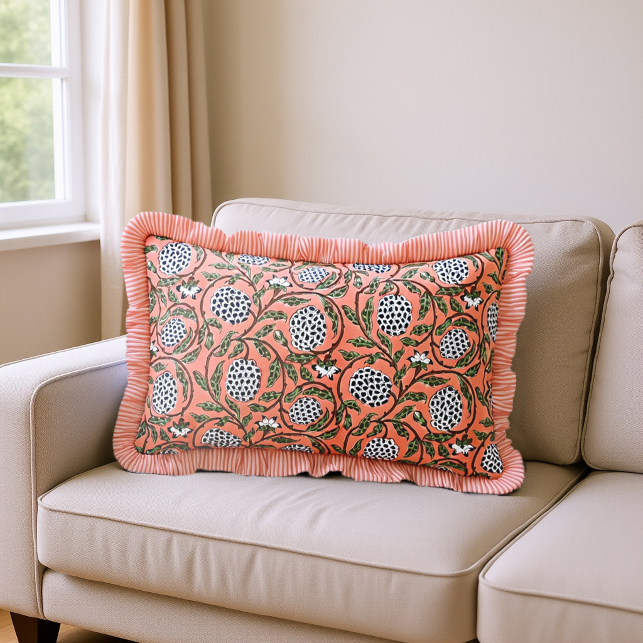 Decorative pillow with floral pattern on a beige sofa near a window.