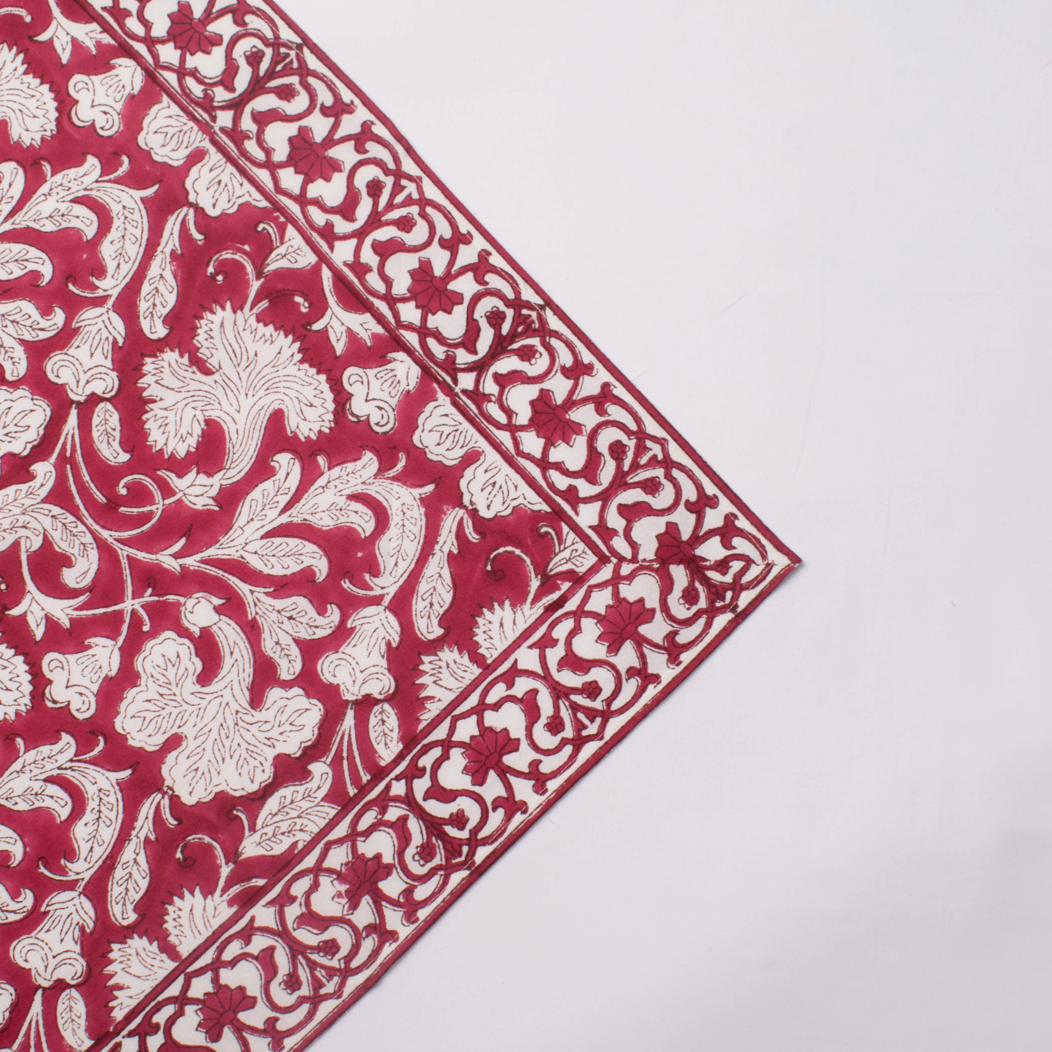 Red and white floral patterned fabric on a white background