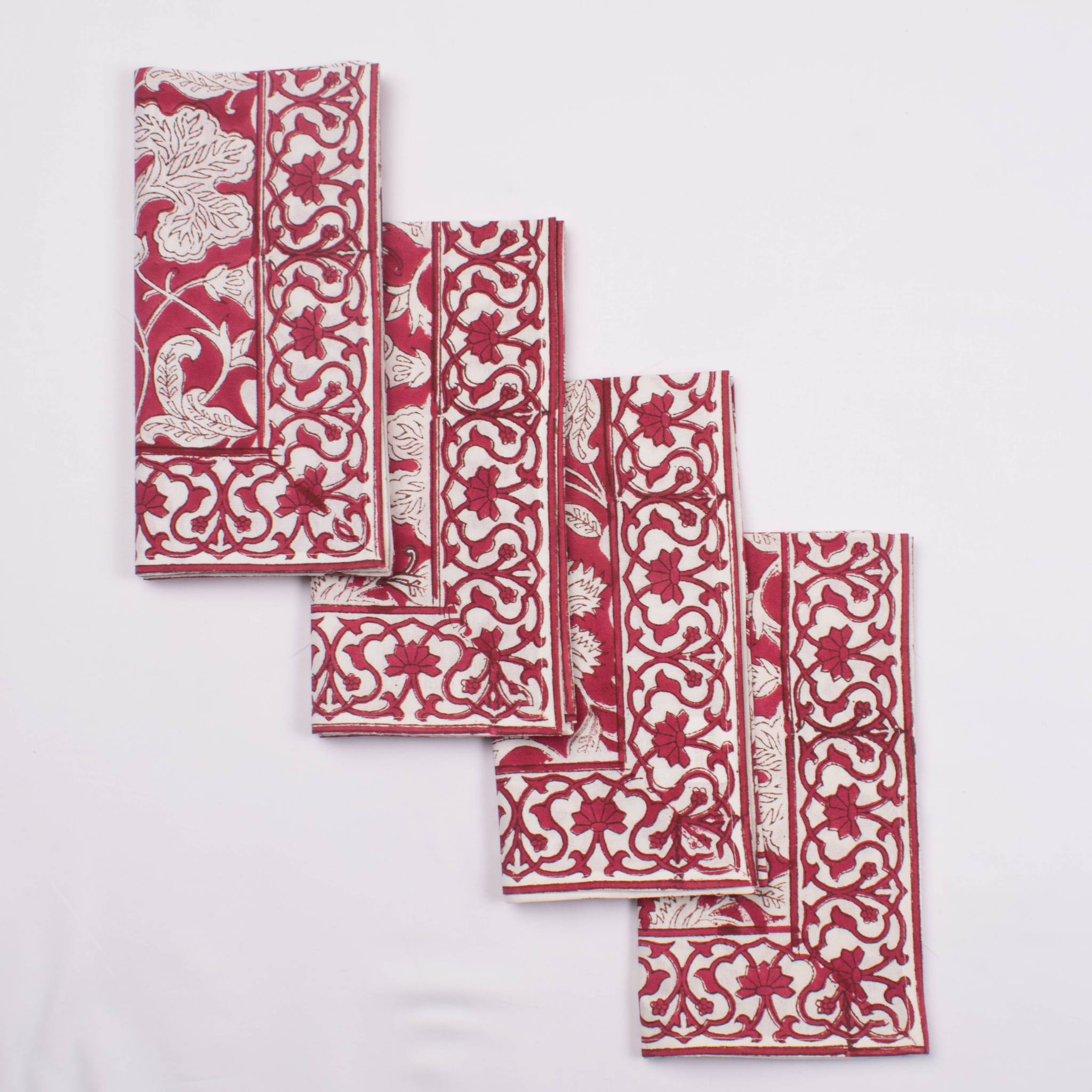 Set of red and white patterned napkins on a light gray background