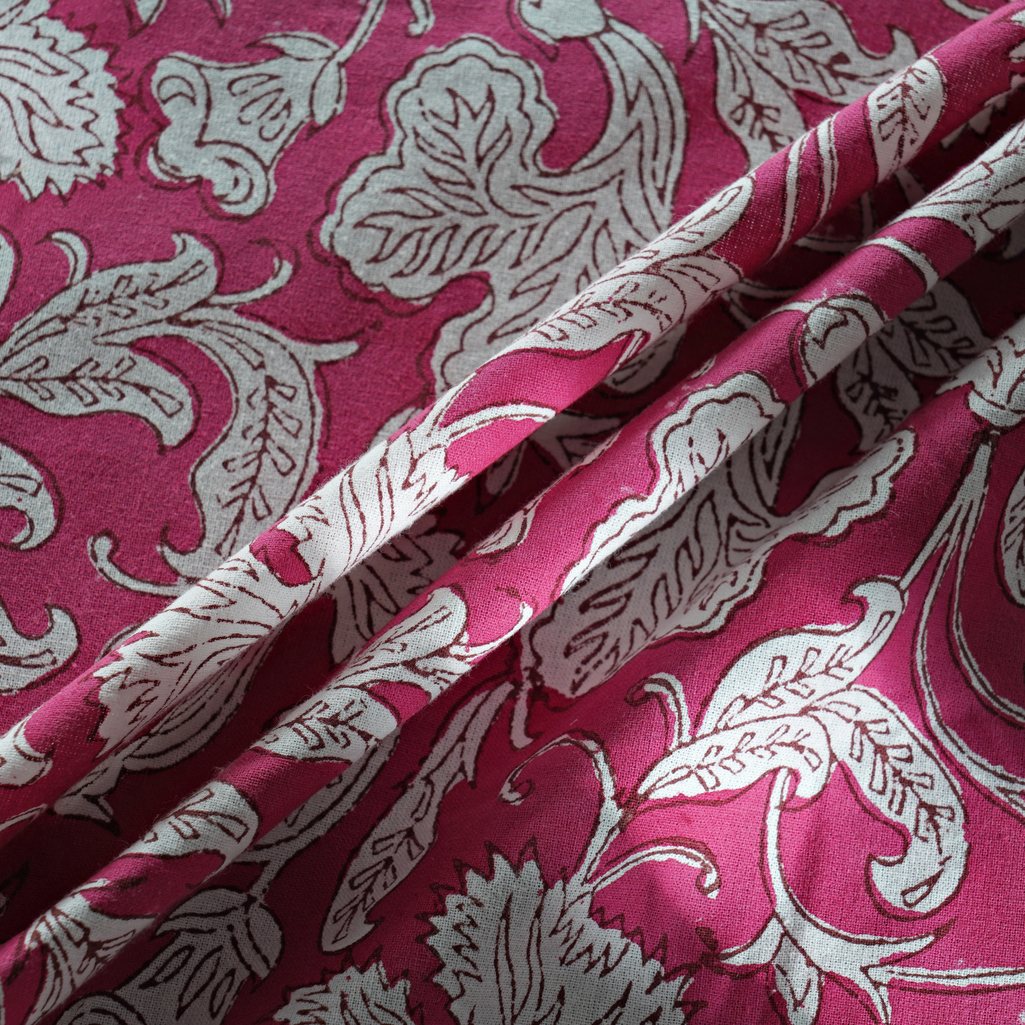 Pink fabric with white floral pattern