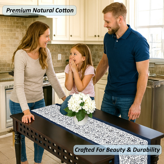 Family in a kitchen with a table runner featuring white flowers.