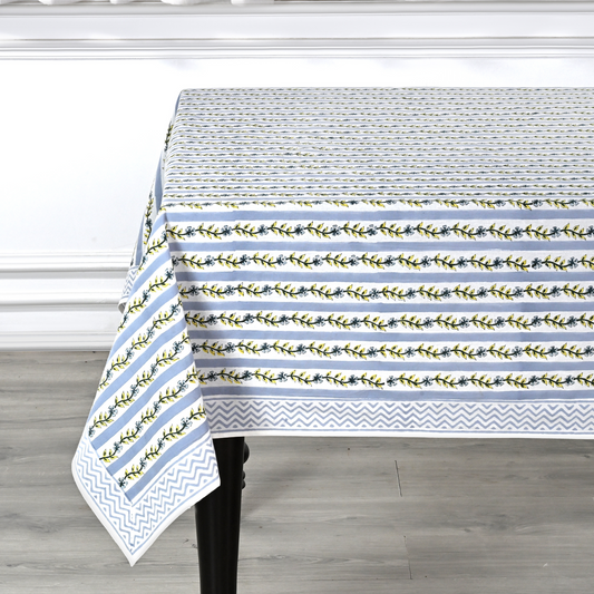 Tablecloth with floral and striped pattern on a wooden table