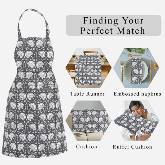 Patterned apron with matching table runner, napkins, cushion, and ruffled cushion on a white background.