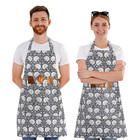 Two people wearing gray aprons with white patterns, standing side by side on a white background.