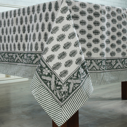 Fabric with leaf pattern draped over a wooden surface