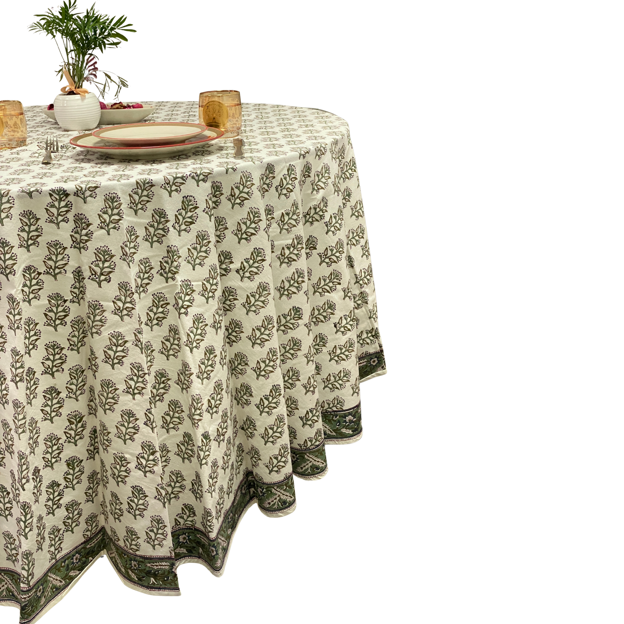 Round table with a floral patterned tablecloth on a white background