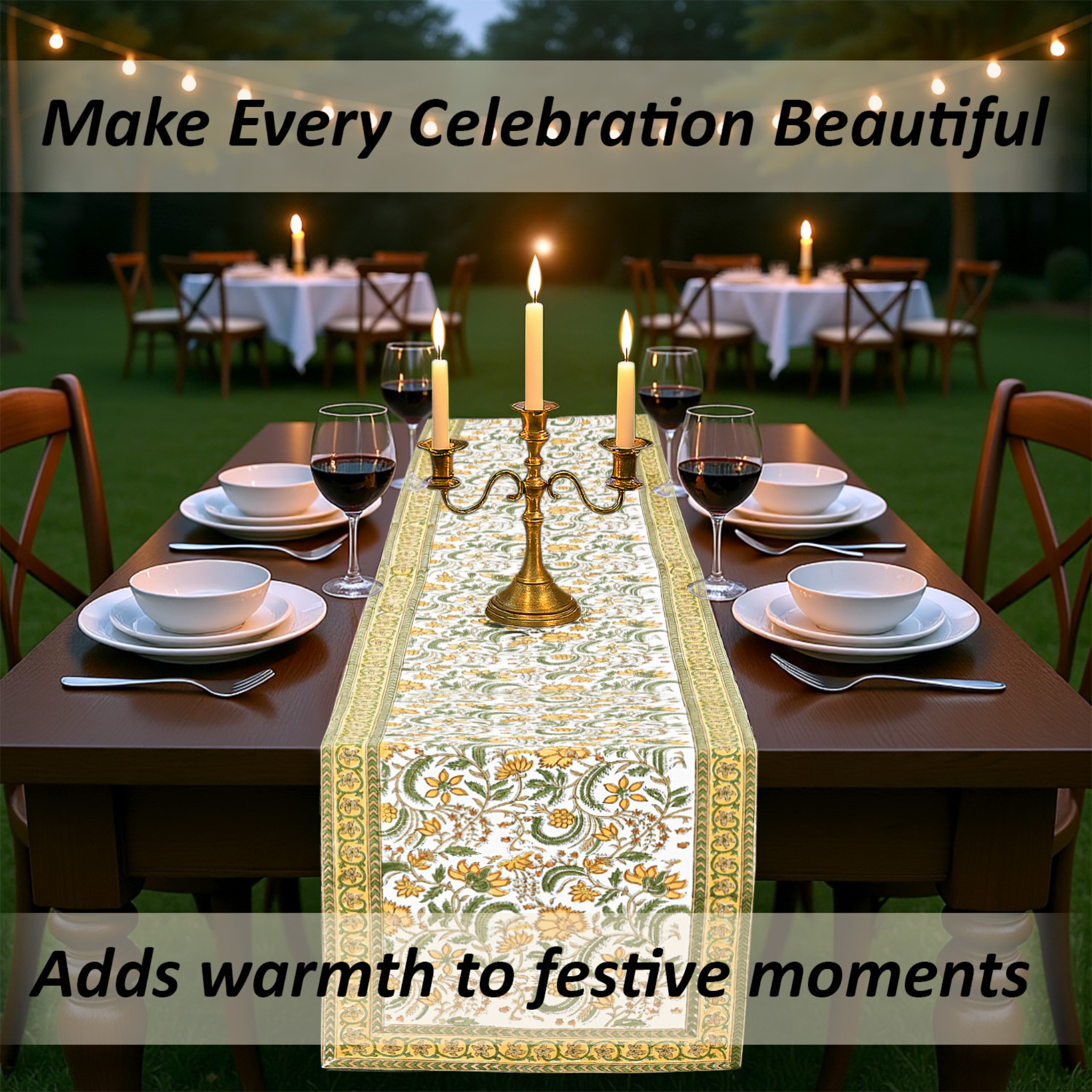 Decorated outdoor table setting with a floral table runner, candles, and wine glasses.