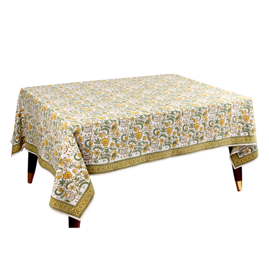 Floral patterned tablecloth on a wooden table with a white background