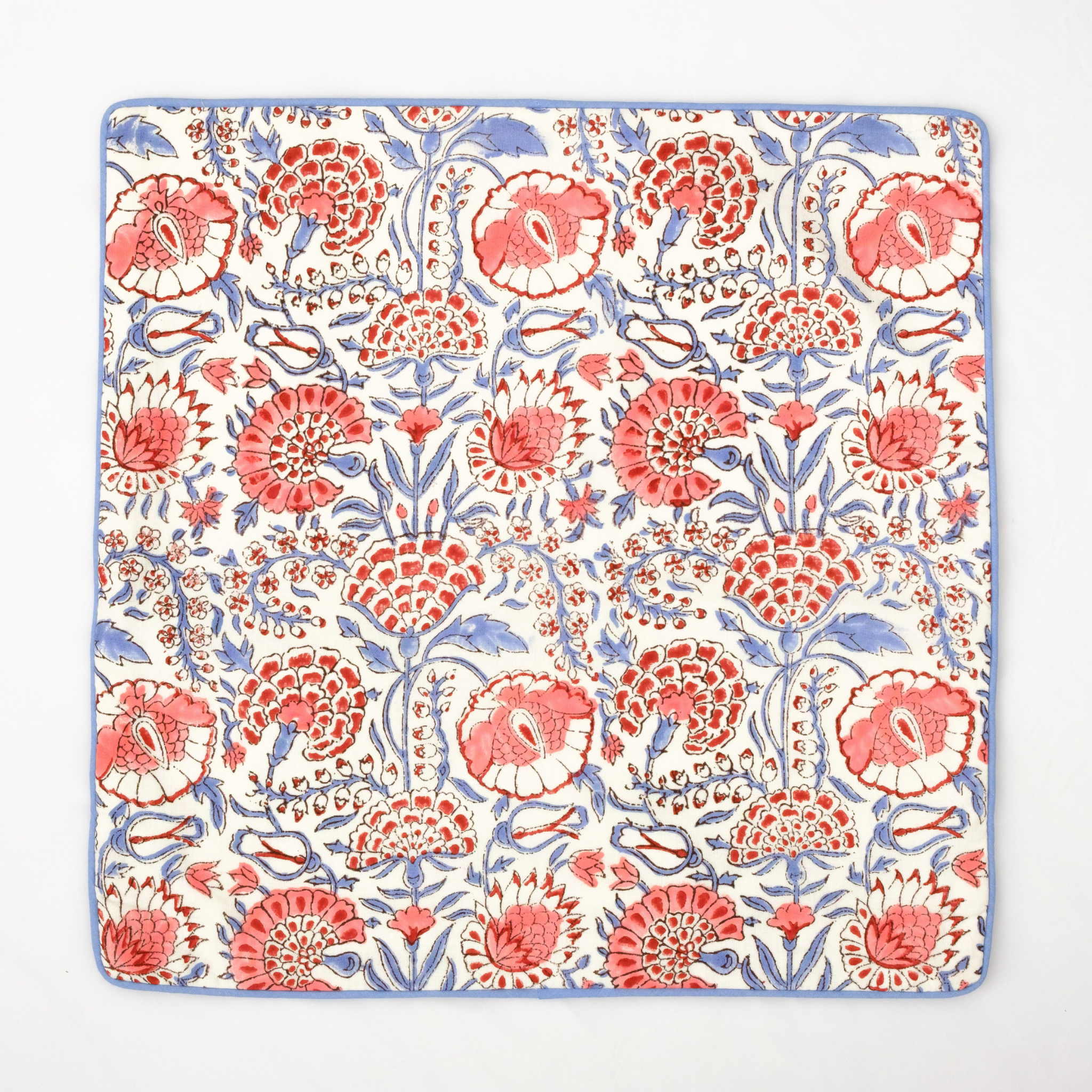 Floral patterned fabric with red and blue flowers on a white background