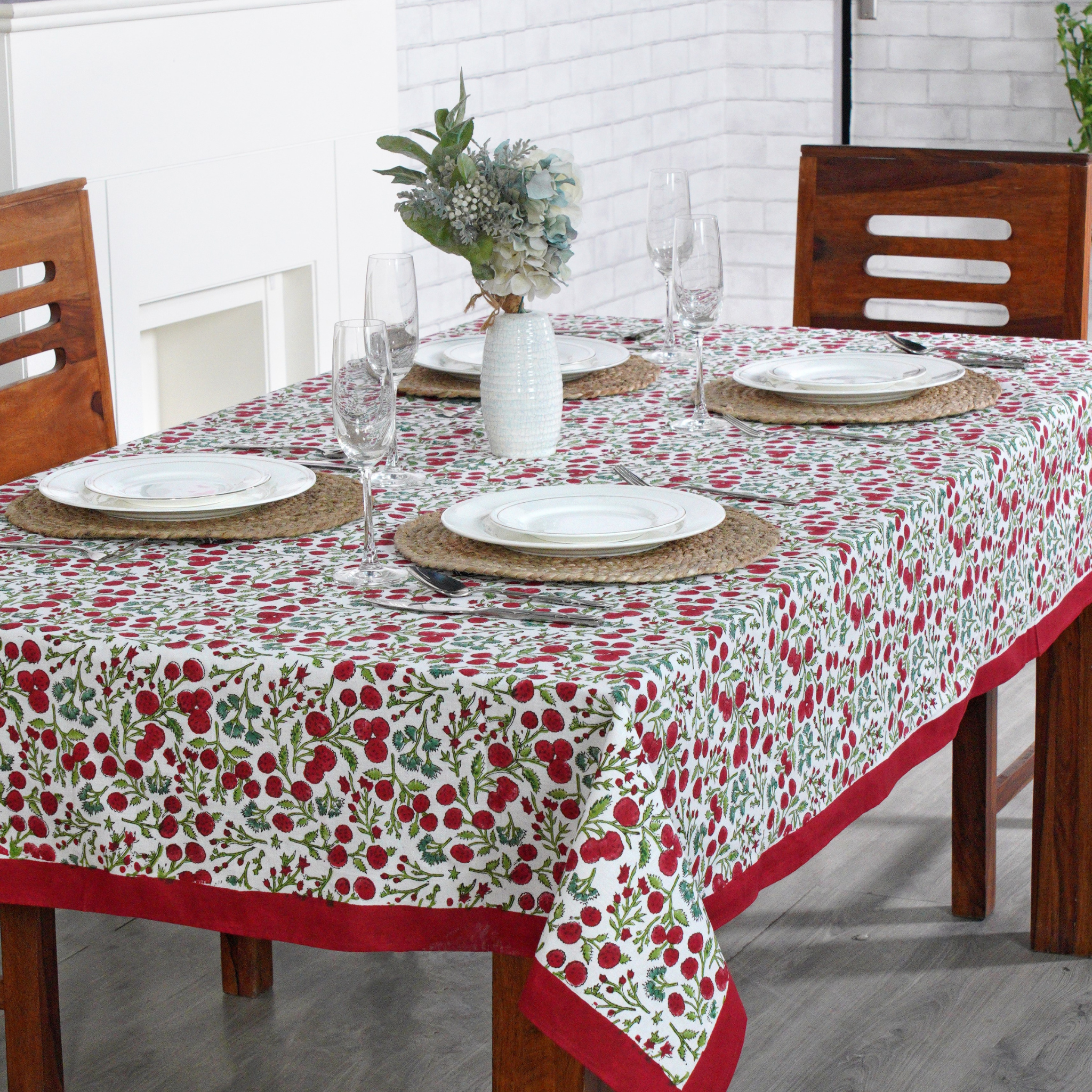 Table setting with a floral tablecloth in a dining room.