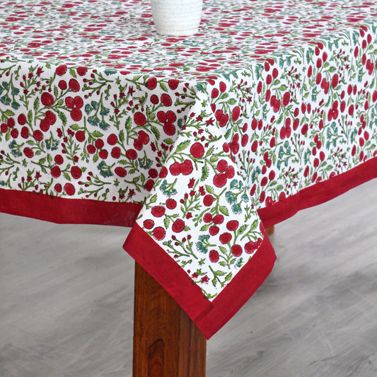 Tablecloth with red and green floral pattern on a wooden table