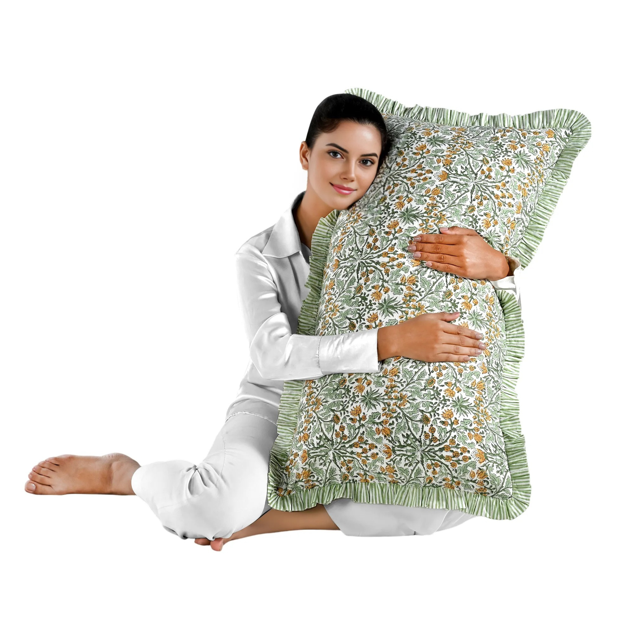 Woman holding a large yellow floral block print cotton pillow with green edges.