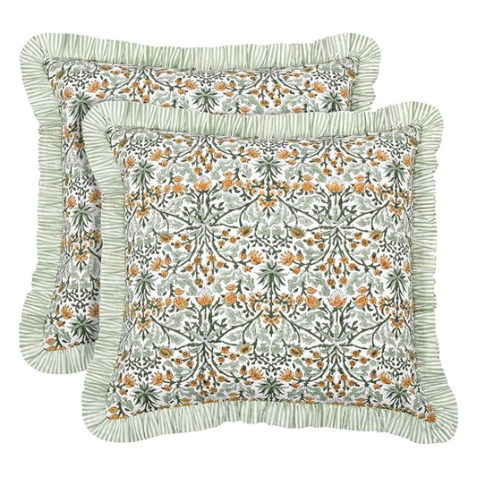 Two floral patterned pillows with ruffled edges on a white background