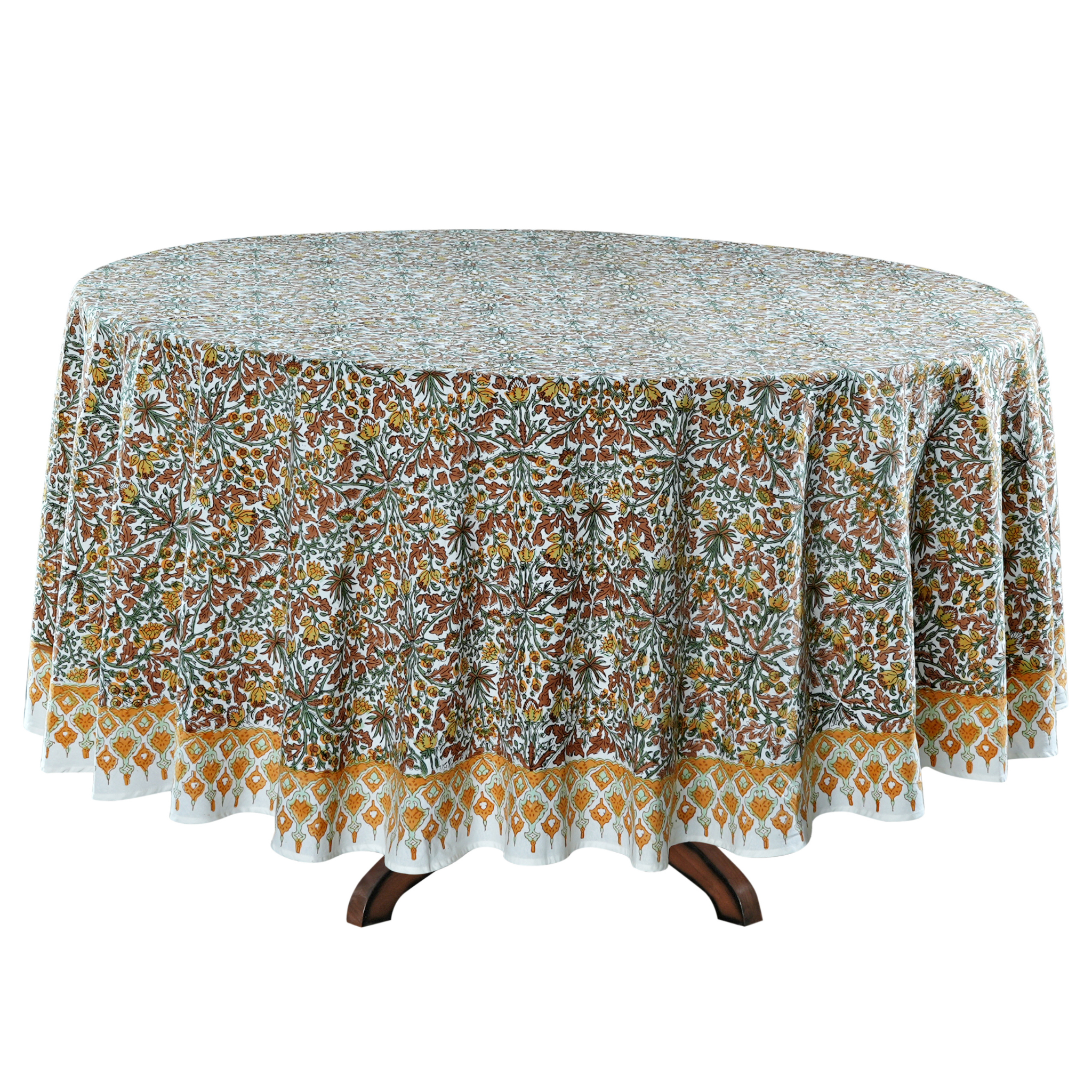 Round table with a floral patterned tablecloth on a white background