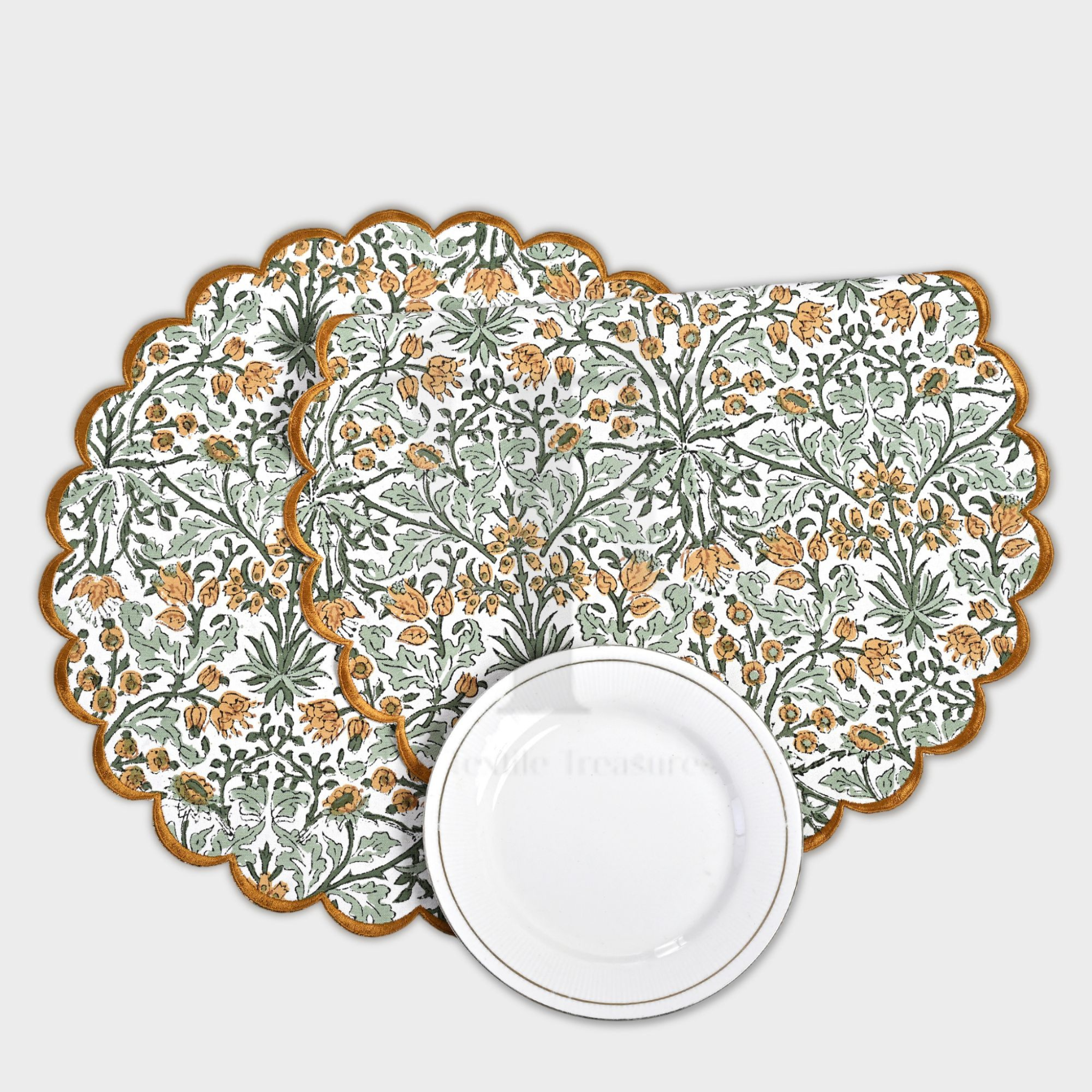 Set of floral placemats with a white plate on a light gray background