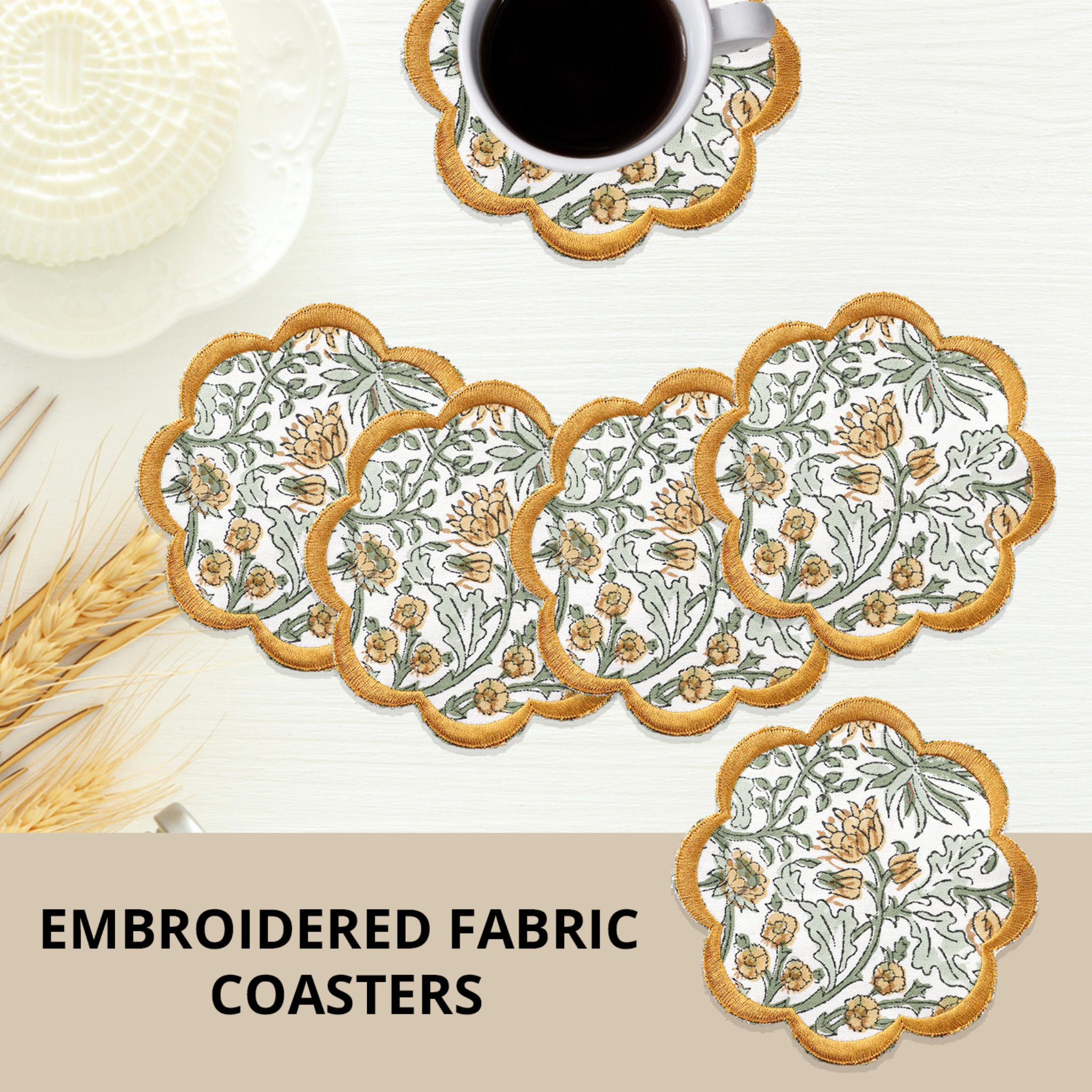 Set of embroidered fabric coasters with a floral design on a white surface.