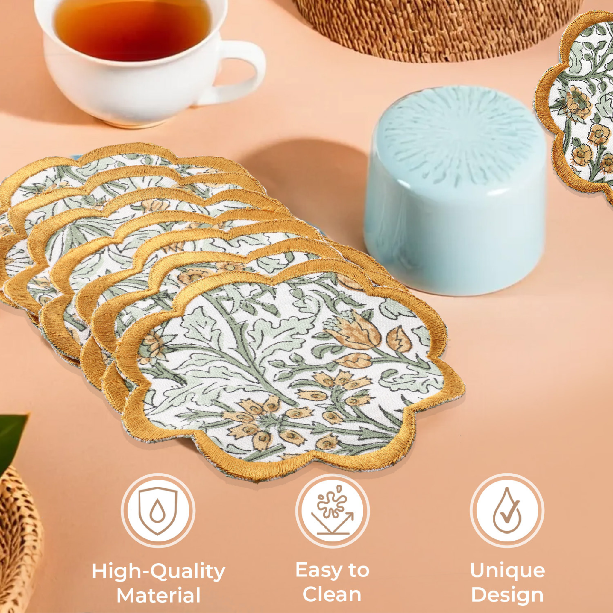 Set of floral placemats with a cup of tea and decorative items on a beige surface