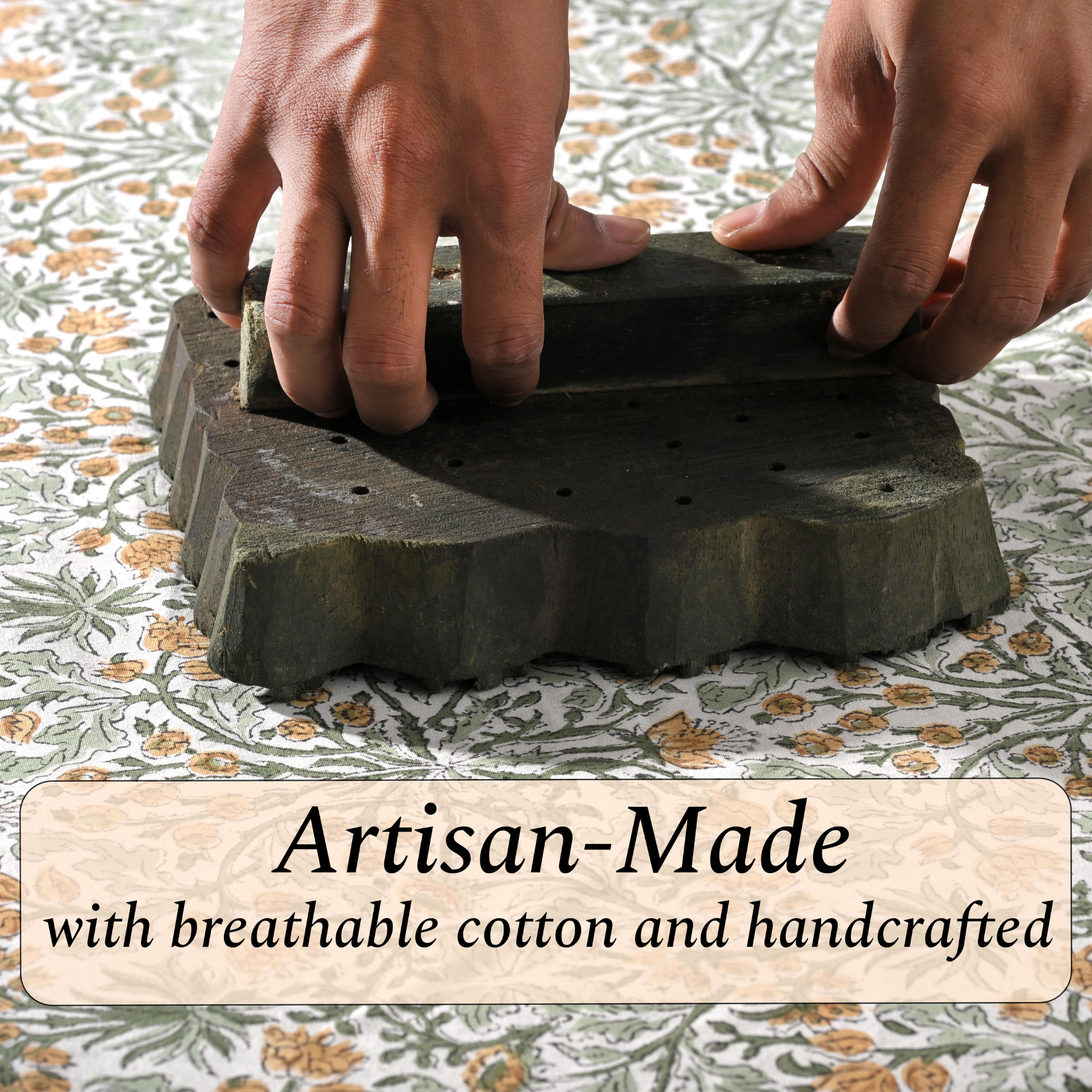 Artisan hand-block printing floral design on cotton fabric.