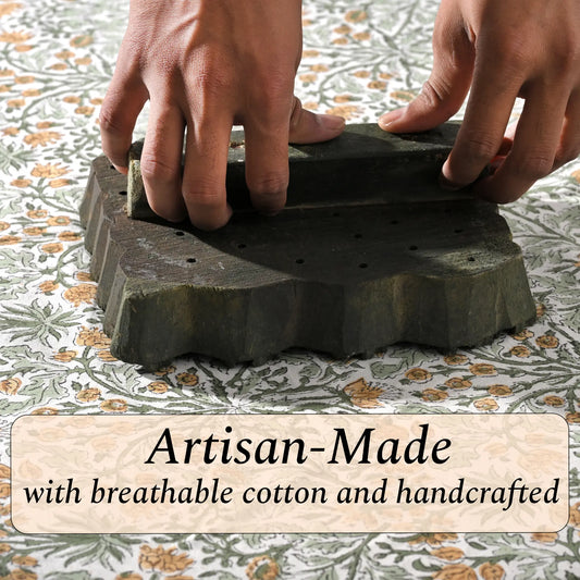 Hands holding a stack of artisan-made stone slabs with text on a patterned fabric background