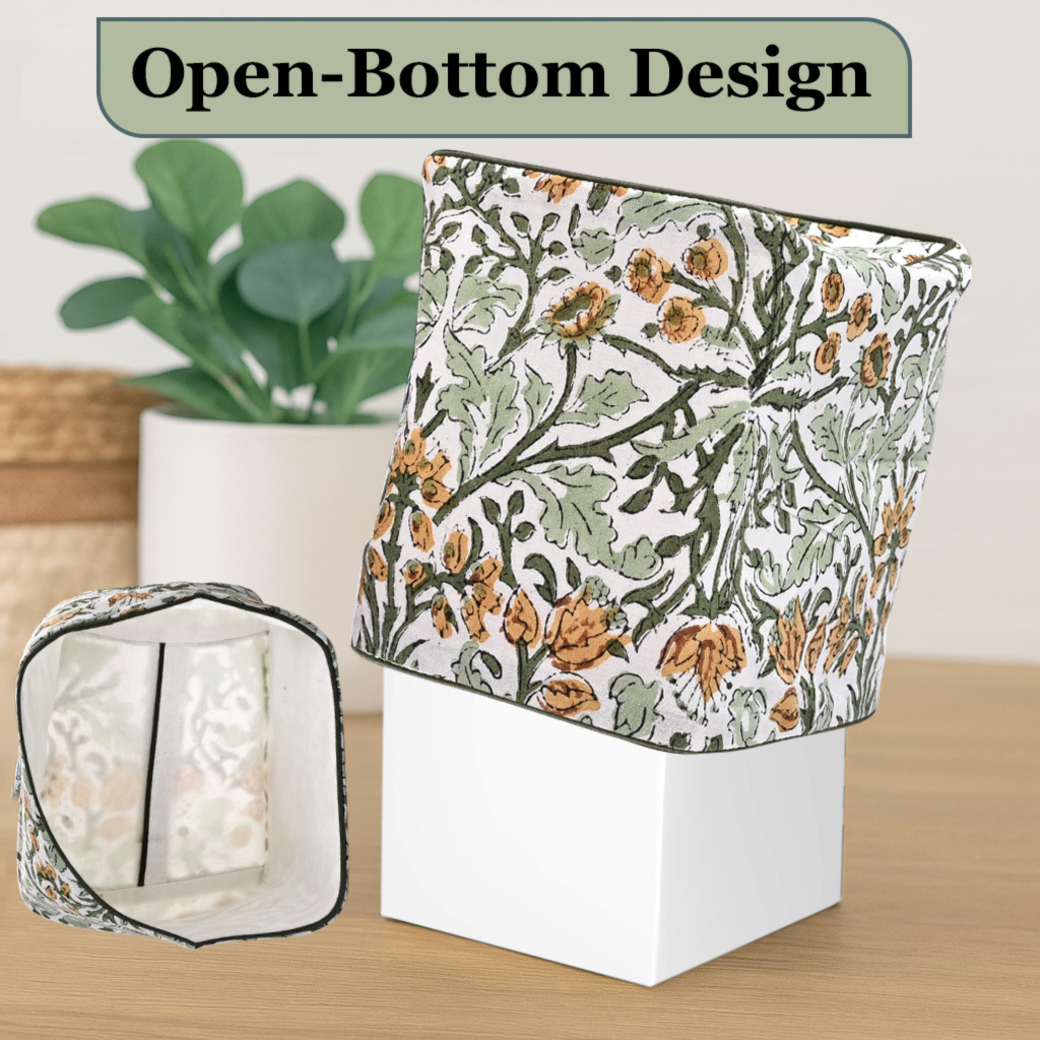 Floral-patterned candle holder with open-bottom design on a wooden surface.