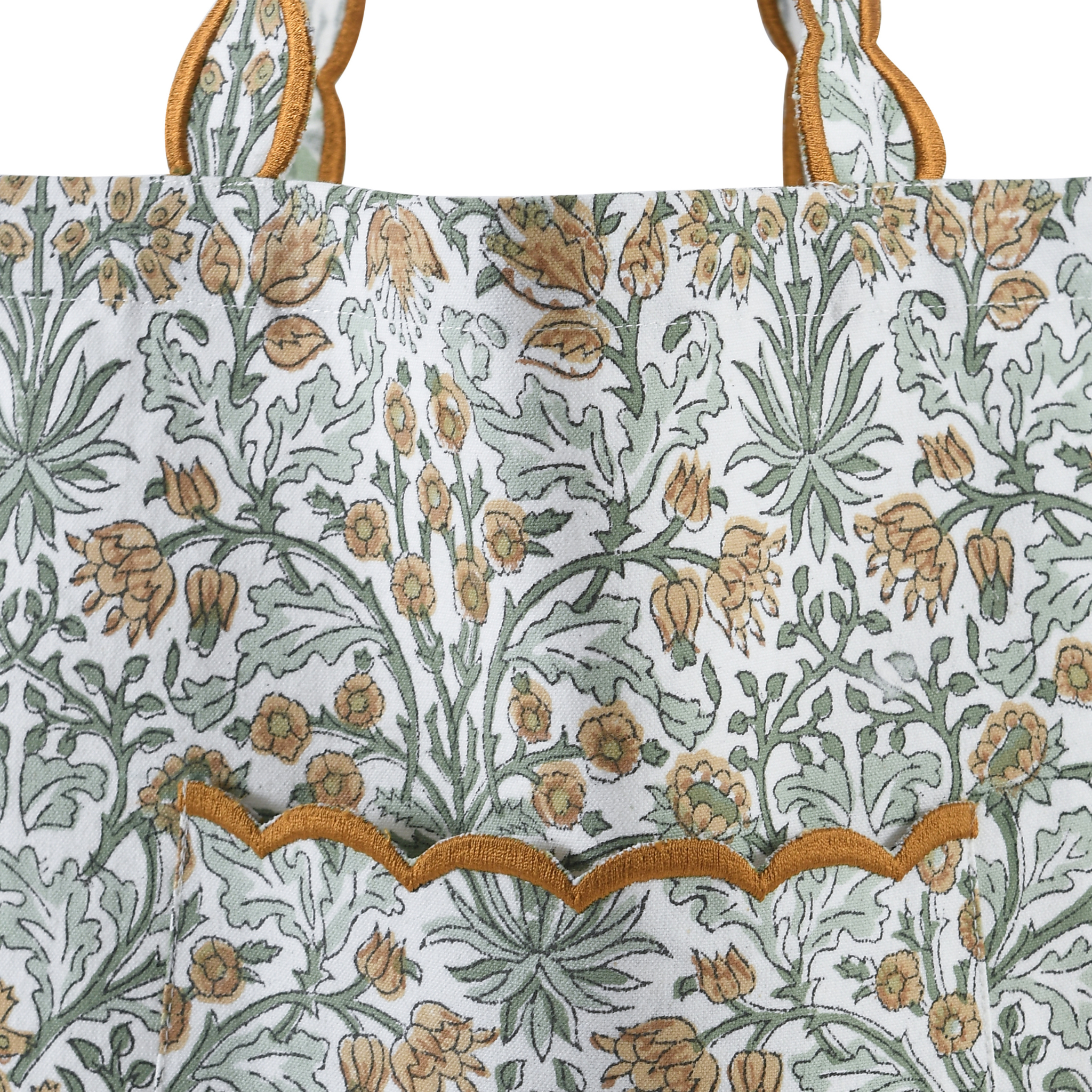 Floral patterned fabric with green and orange design on a white background