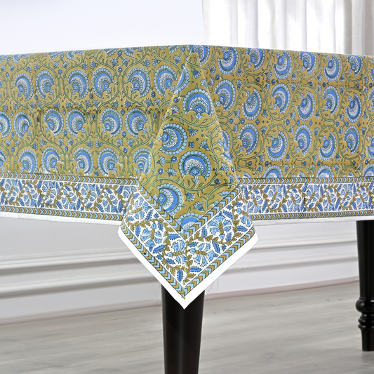 Patterned tablecloth on a table with a white curtain background