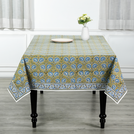 Tablecloth with a blue and yellow pattern on a wooden table.