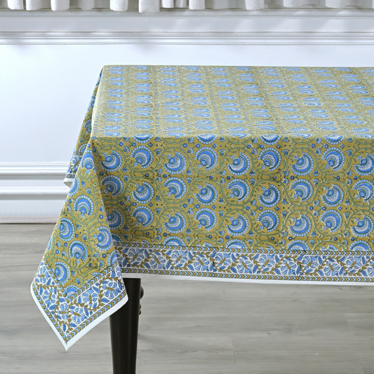 Tablecloth with blue and green pattern on a wooden table