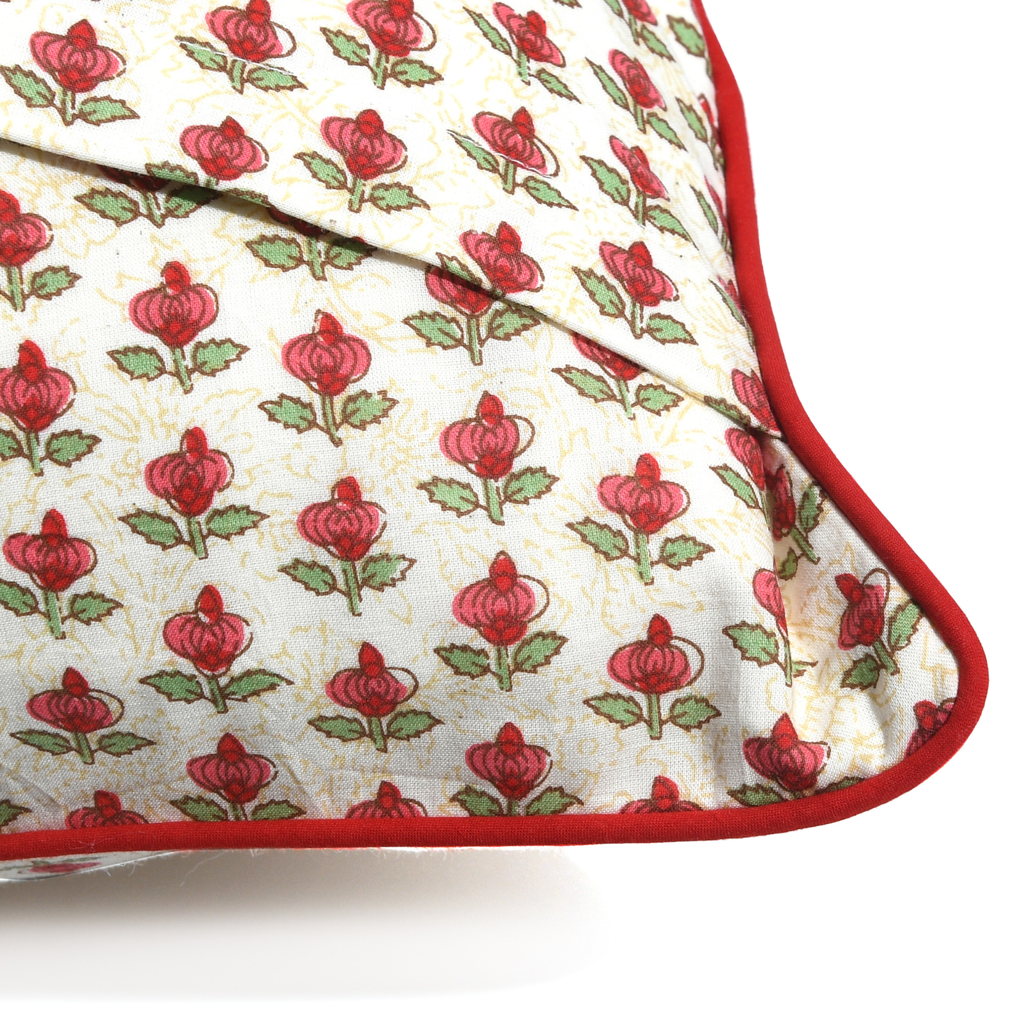 Floral patterned fabric with red flowers and green leaves on a white background