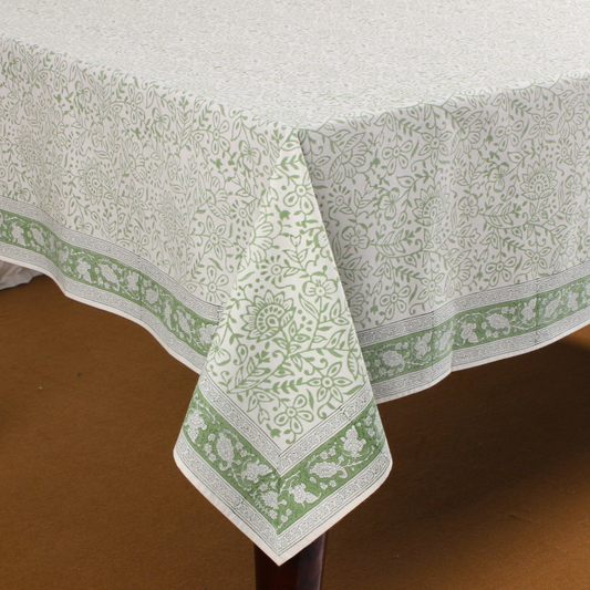 Green and white patterned tablecloth on a wooden table