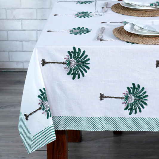 Tablecloth with green floral patterns on a wooden table