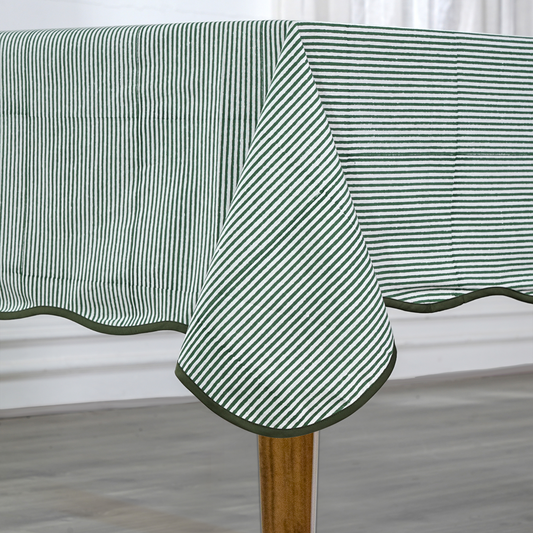 Green and white striped tablecloth on a wooden table with a neutral background