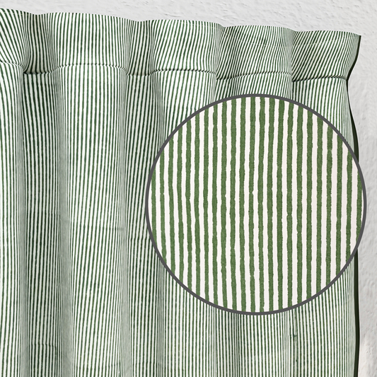 Green and white striped fabric with a close-up of a circular section.